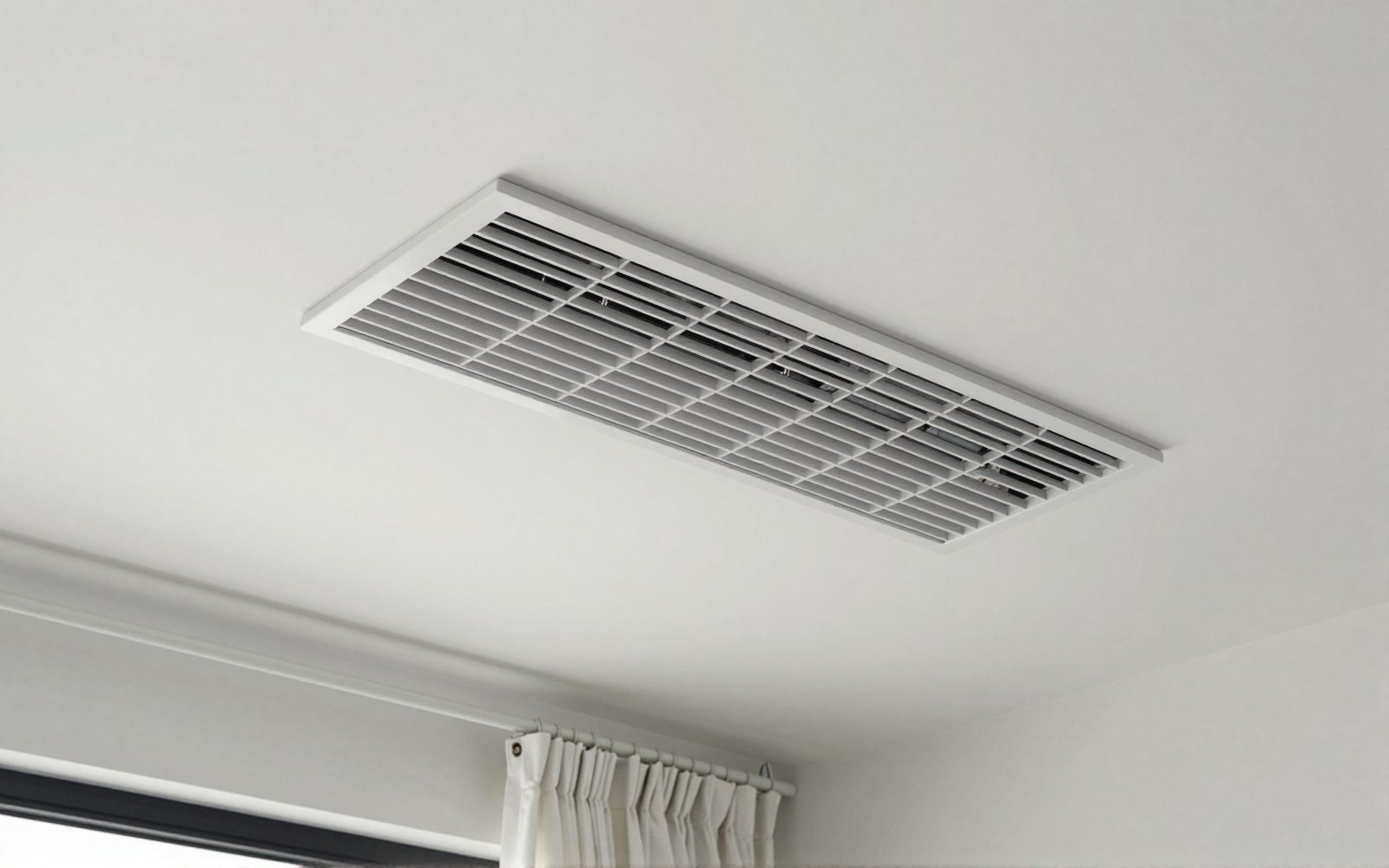 Illustration: a slim white ducted air conditioning ceiling vent in a modern living room